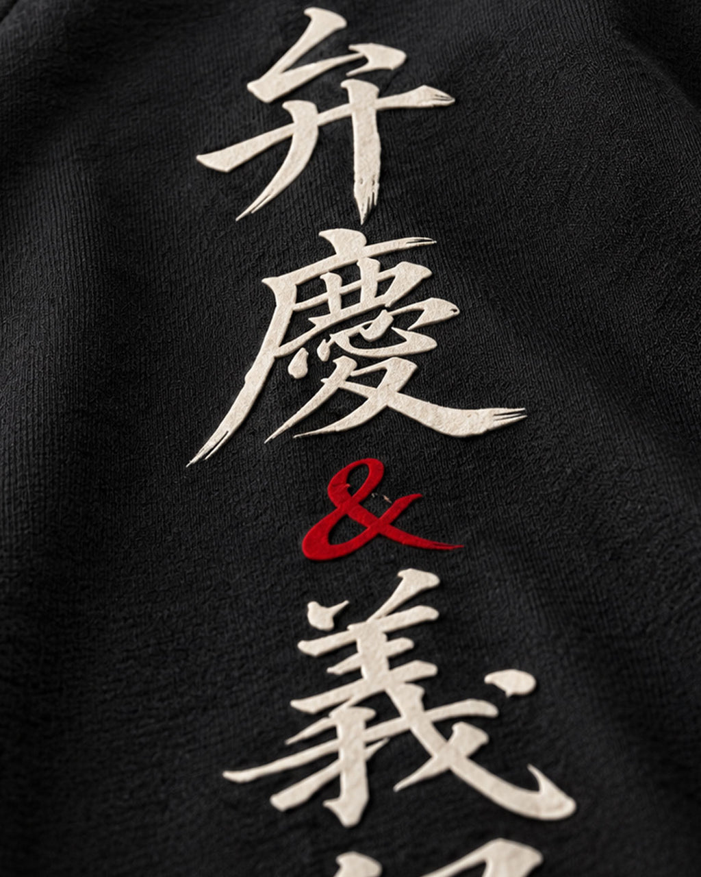 Gros plan de l'imprimé poitrine, calligraphie blanche et rouge sur coton noir